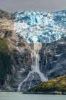 Chile, Beagle Channel, Alberto de Agostini National Park. Landscape with glacier and waterfall. Art Print